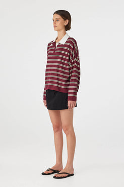 Side view of Eames Mini Skirt in black, cotton mini skirt with side seam pocket and fitted waist.