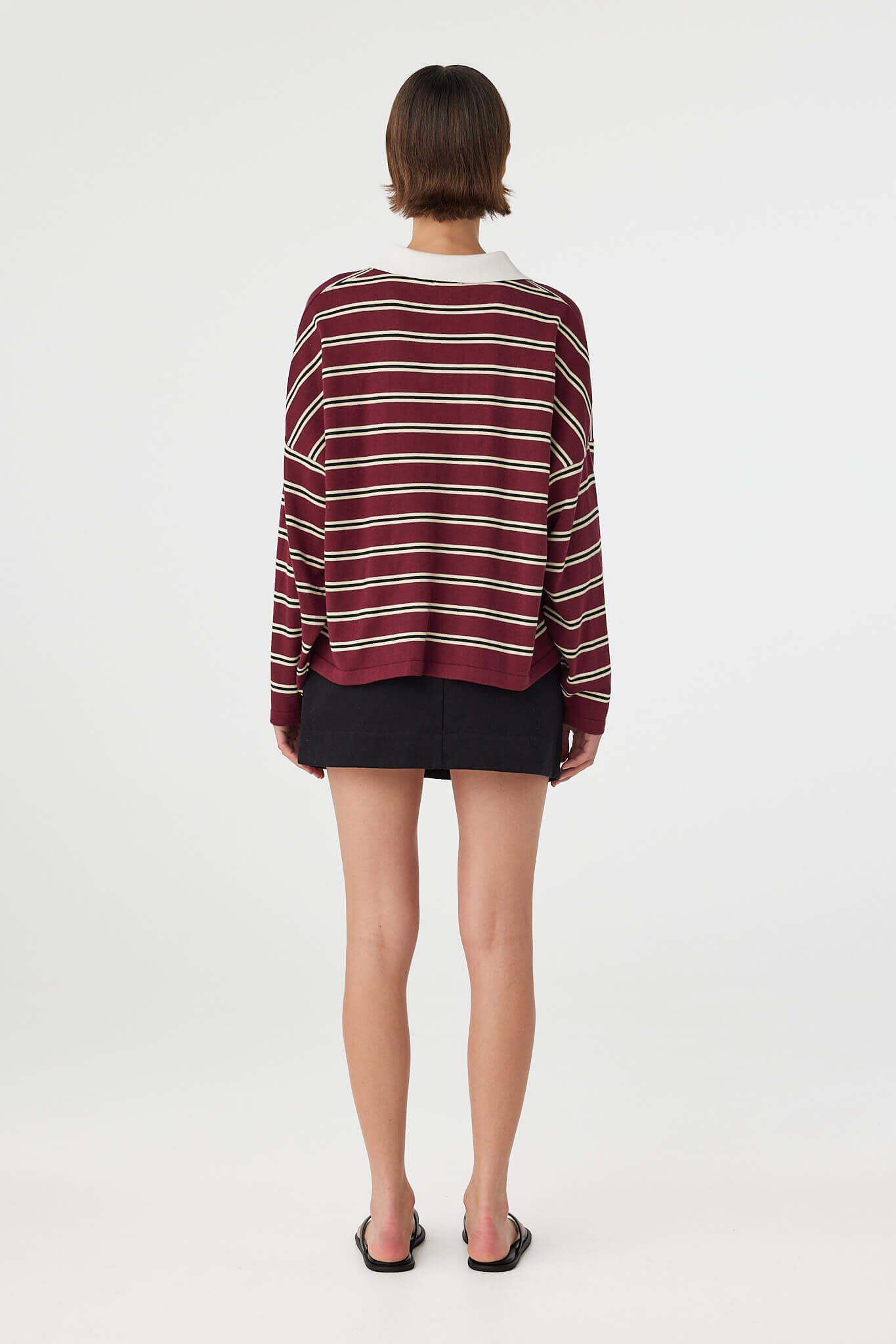 Back view of Eames Mini Skirt black, cotton mini skirt showing clean back silhouette.