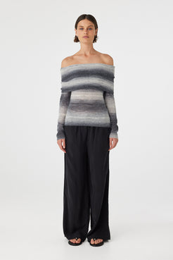 Nikki off the shoulder top in grey and cream ombre knit featuring a soft foldover neckline and fitted silhouette, styled with relaxed black wide leg pants