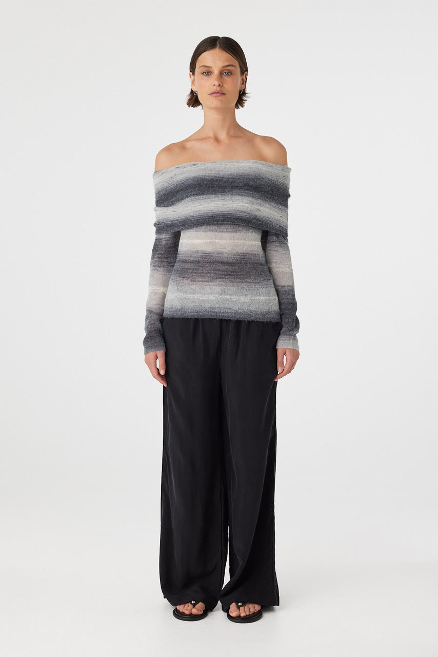 Nikki off the shoulder top in grey and cream ombre knit featuring a soft fold over neckline and fitted silhouette, styled with relaxed black wide leg pants