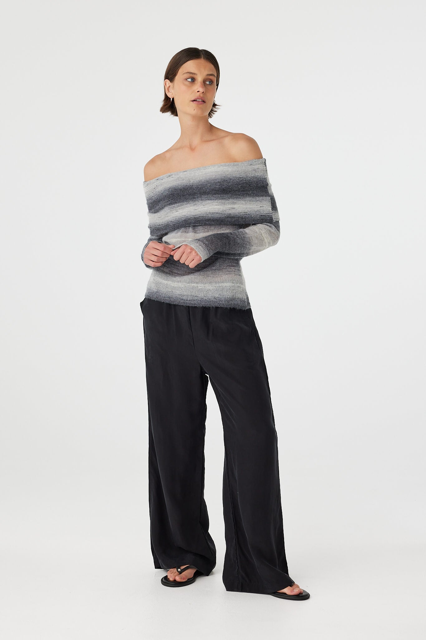Nikki off the shoulder top in grey ombre knit styled with fluid black trousers, featuring a softly structured foldover neckline and lightweight drape