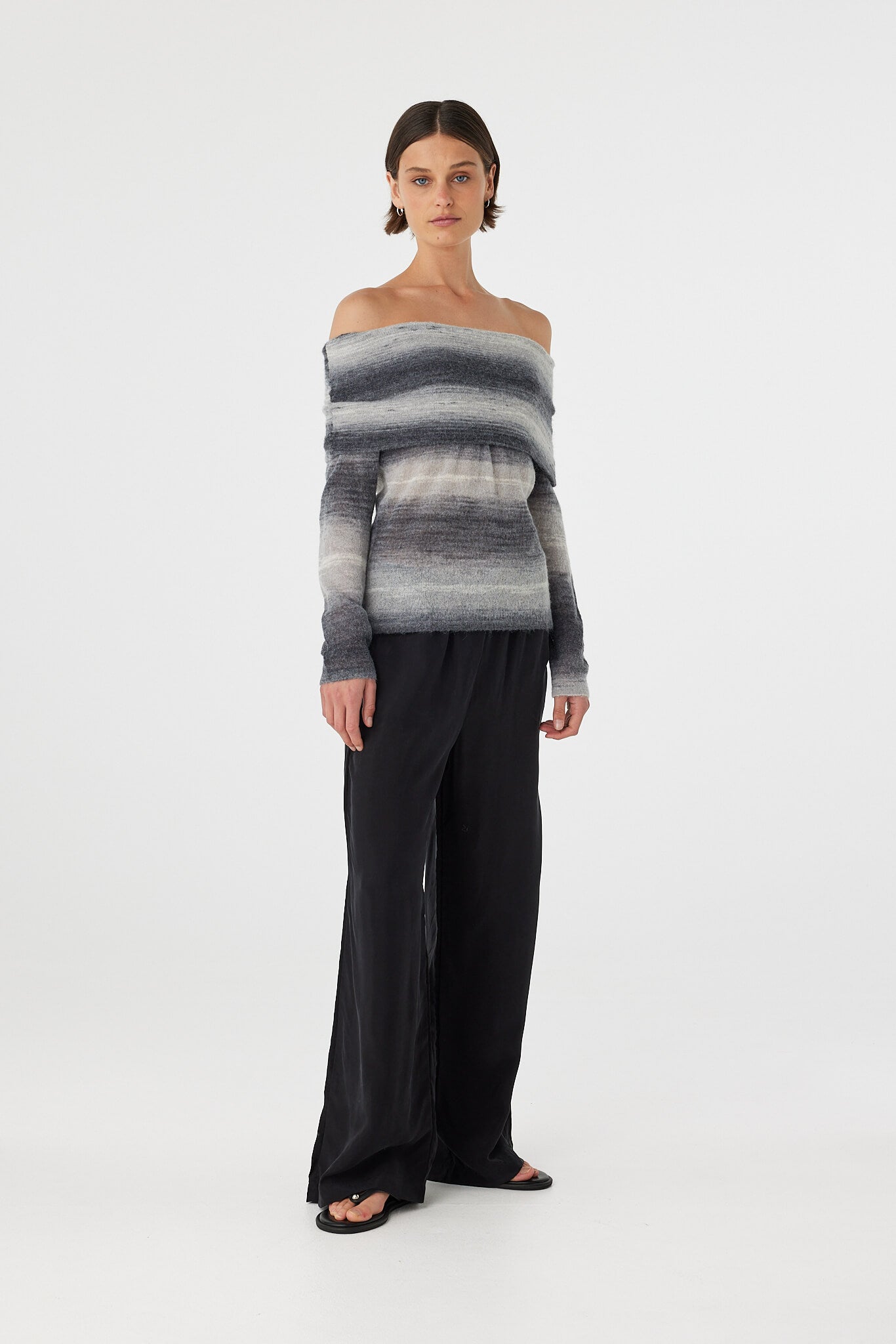 Nikki off the shoulder top in grey and cream ombre worn slightly angled, showcasing the natural drape and fine knit texture