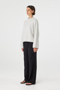 Maeve sweater in snow marle shown in side profile, highlighting the dropped shoulders, wide sleeves and soft lightweight knit