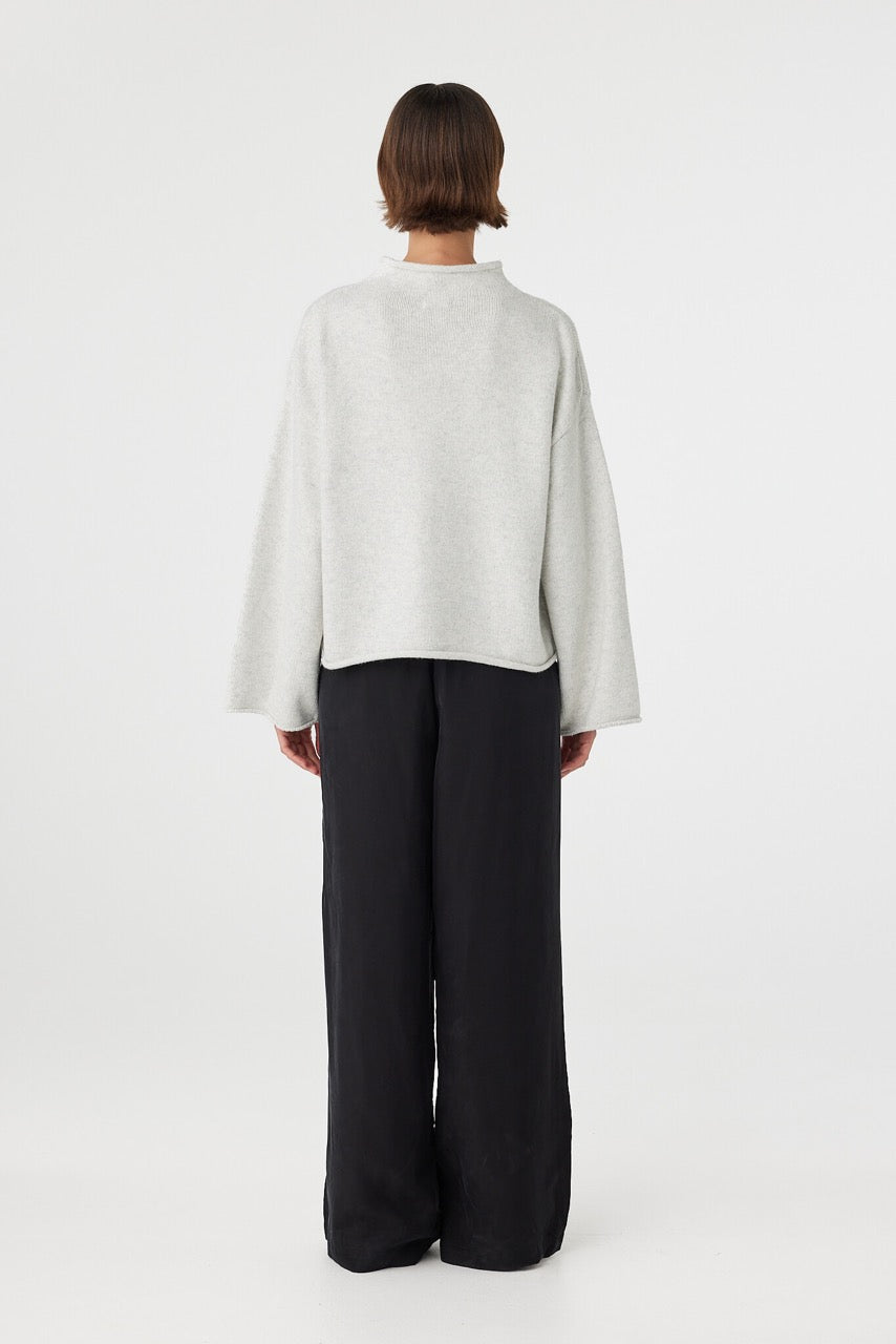 Maeve sweater in snow marle shown in side profile, highlighting the dropped shoulders, wide sleeves and soft lightweight knit