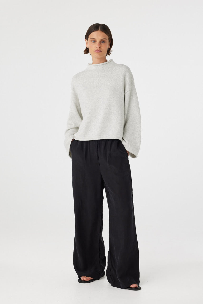 Maeve sweater in snow marle styled with black trousers, showcasing the soft knit texture, wide sleeves and natural drape