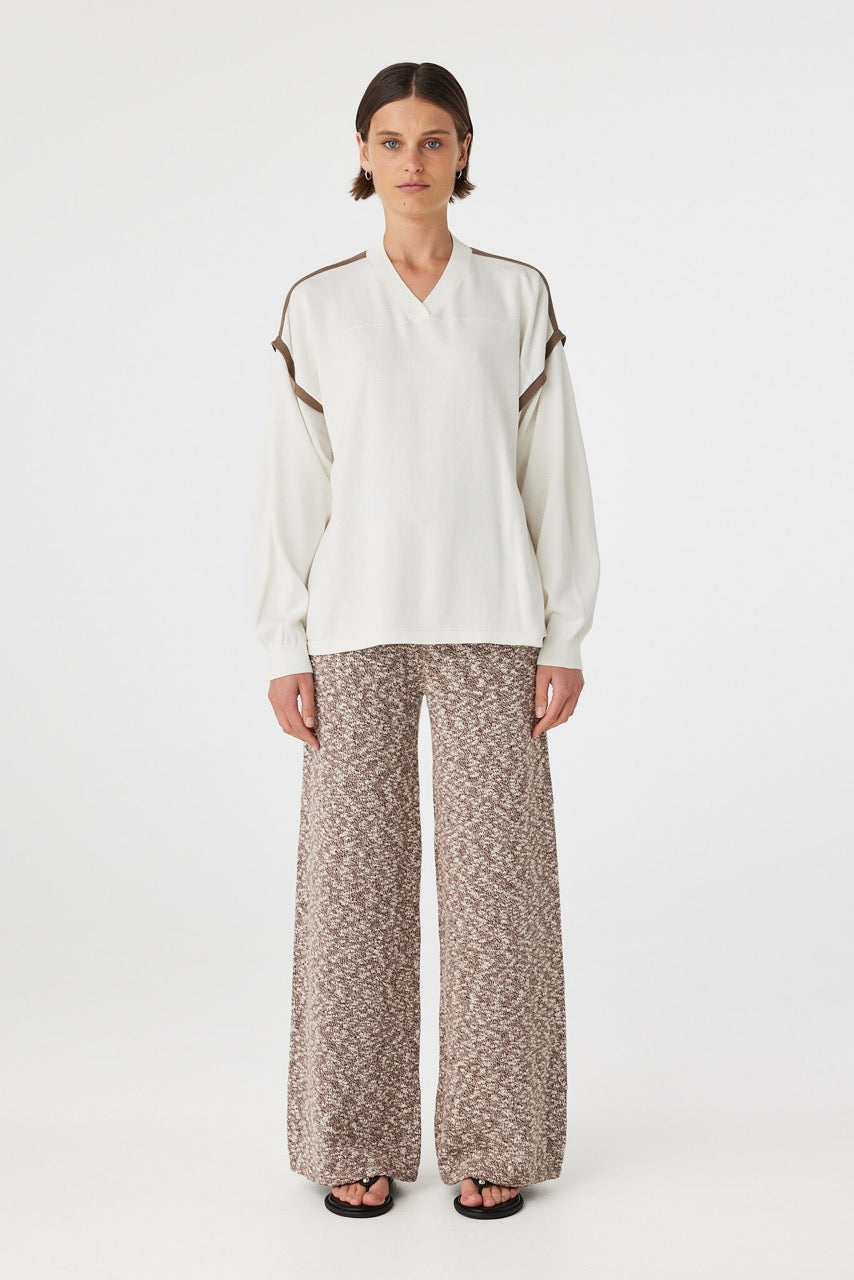 Emmet Pant chocolate & cream front view straight leg knit pants with high-rise ribbed waistband styled with cream long sleeve top and black sandals