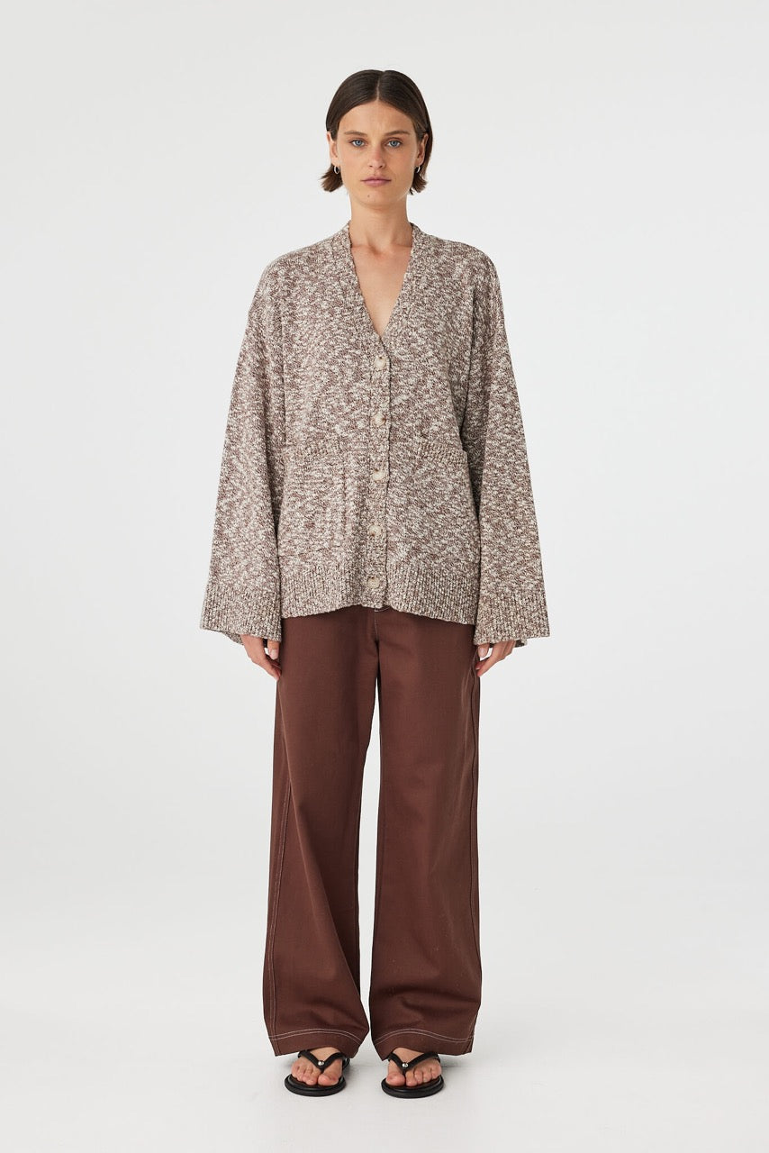 Emmet cardigan in chocolate and cream worn front on, highlighting the soft drape, wide sleeves and front patch pockets, styled with brown wide-leg pants and sandals
