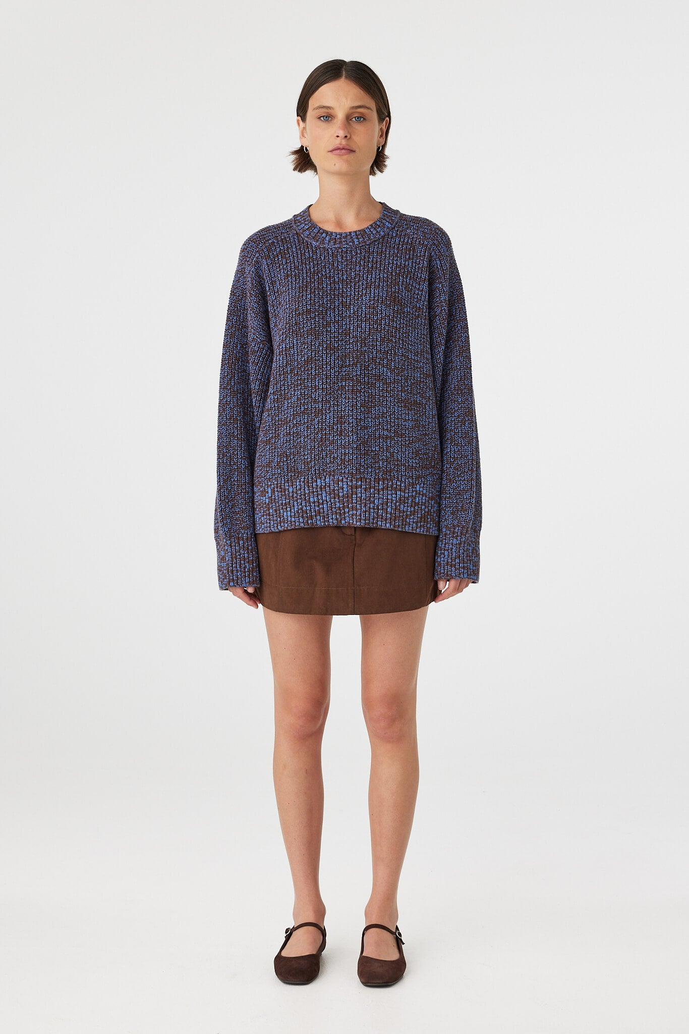 Eames mini skirt in espresso styled with a knit sweater, showing the overall fit and length on the body