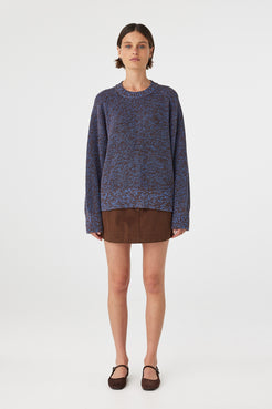 Eames mini skirt in espresso styled with a knit sweater, showing the overall fit and length on the body