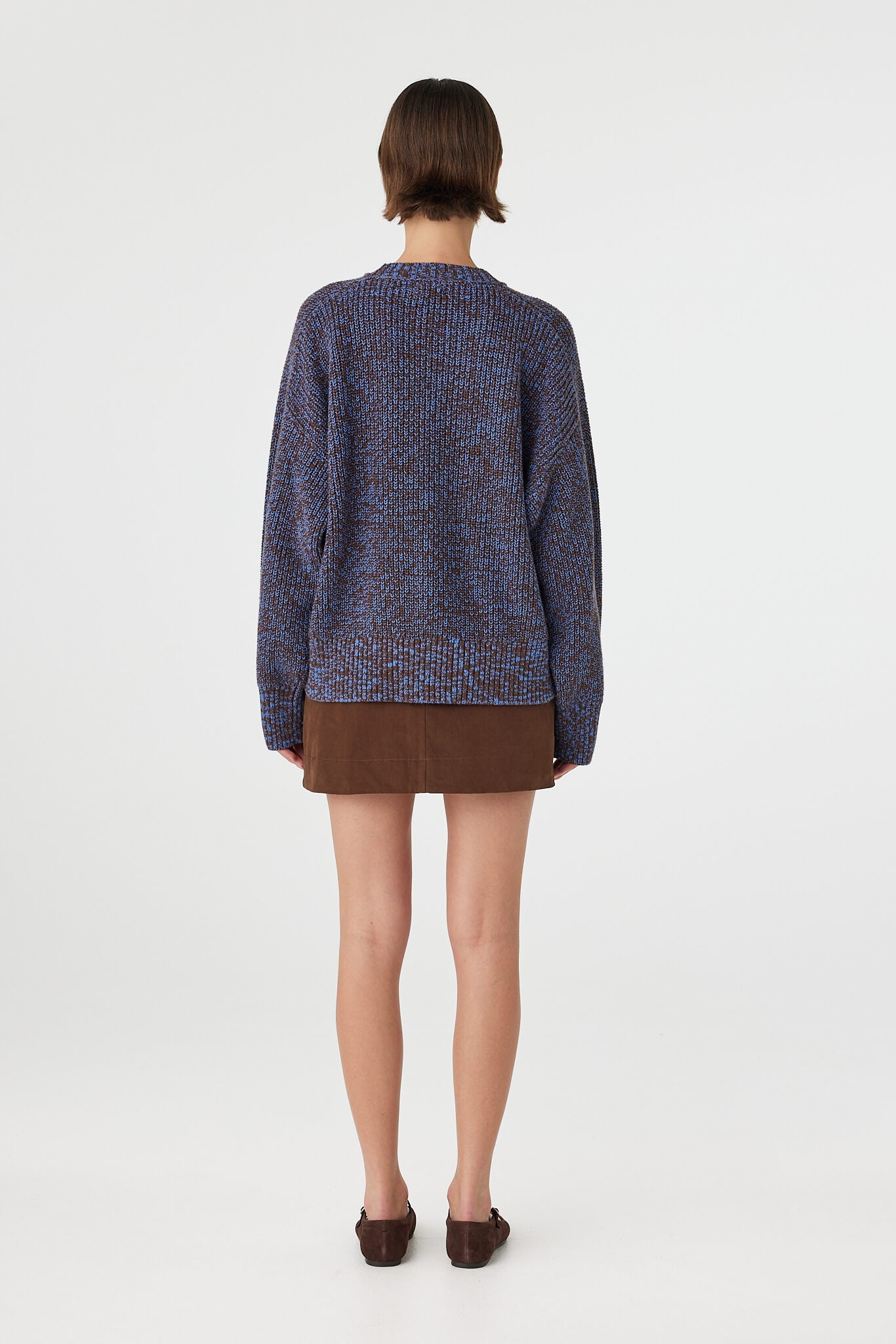 Eames mini skirt in espresso viewed from back, featuring the adjustable side tabs, back pocket detail and tailored fit