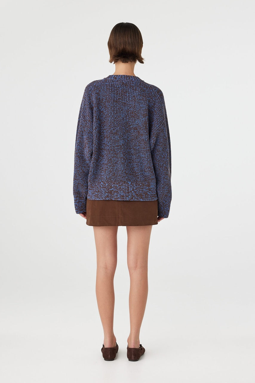 Eames mini skirt in espresso styled with a knit sweater from the back, showcasing the waistband details and silhouette