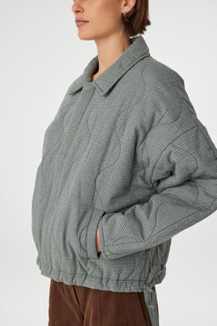 Side view Close detail of Matteo Jacket blue check, quilted cotton texture with drawstring hem tie.