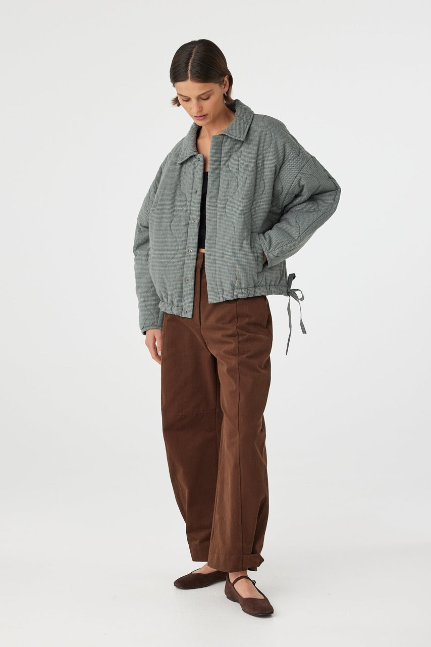 Three-quarter view of Matteo Jacket blue check, drawstring hem and side pocket placement.