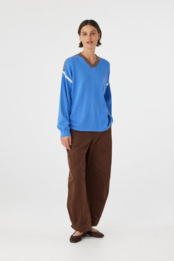 Eden long sleeve tee in royal blue and espresso worn at an angle, showcasing the contrast stripe detail along the shoulder and armhole