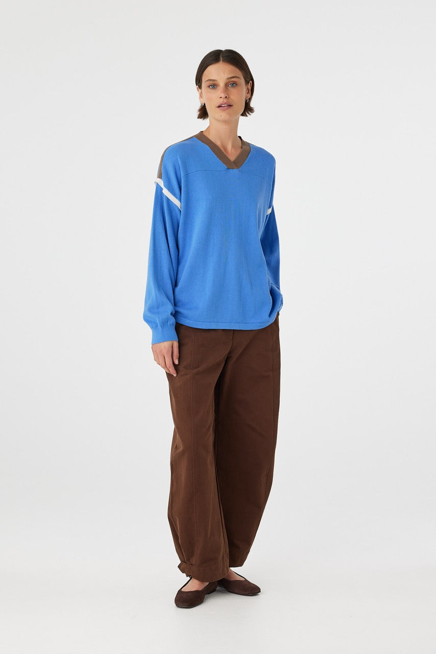 Eden long sleeve tee in royal blue and espresso worn at an angle, showcasing the contrast stripe detail along the shoulder and armhole