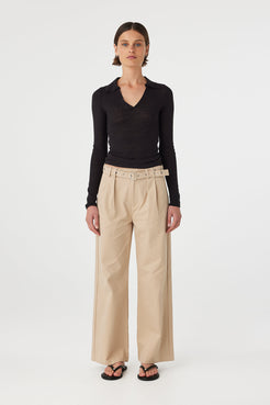 Soraya Pant taupe front view wide leg tailored pants with statement belt and pleated front styled with black long sleeve top and sandals