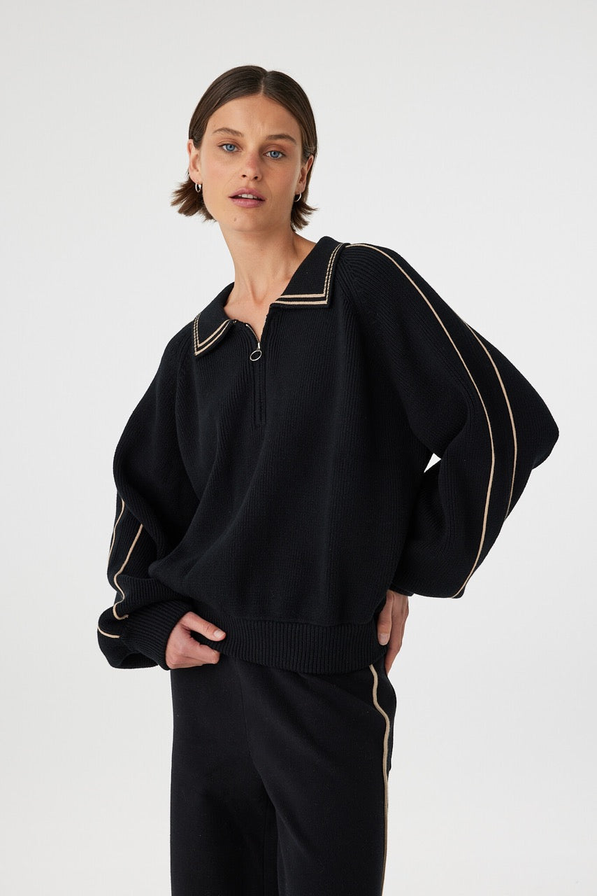 Nella zip sweater in black and taupe worn front on, showing the soft cotton knit, ribbed hem and cuffs and overall relaxed silhouette