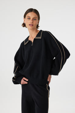 Nella zip sweater in black and taupe worn front on, showing the soft cotton knit, ribbed hem and cuffs and overall relaxed silhouette