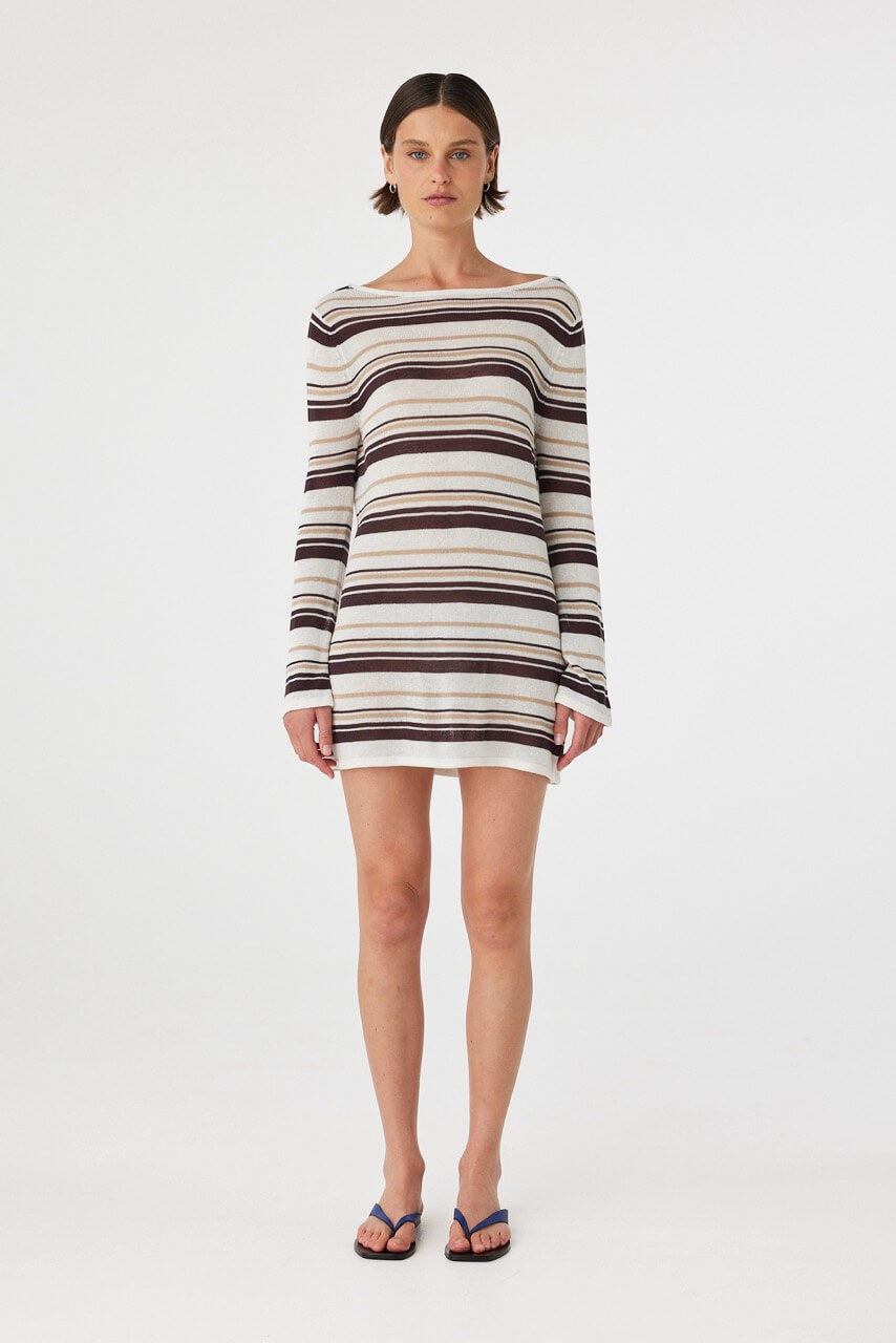Model wears a long sleeve mini dress in sheer striped cotton knit with a relaxed fit and boat neckline, ideal for layering over swim.