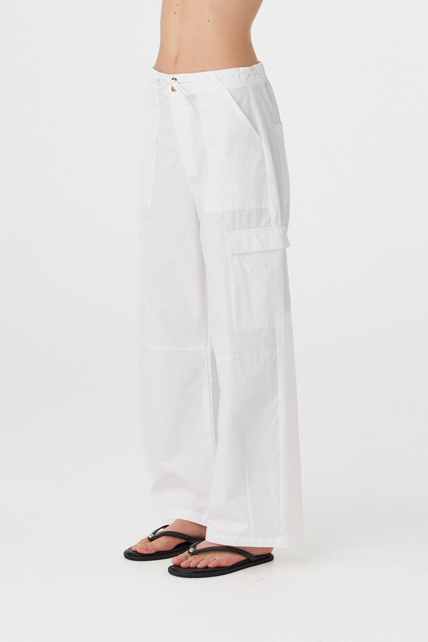 Utility-inspired 100% cotton pant seen from the side, with clean tailoring and subtle texture in a summer-weight fabric.