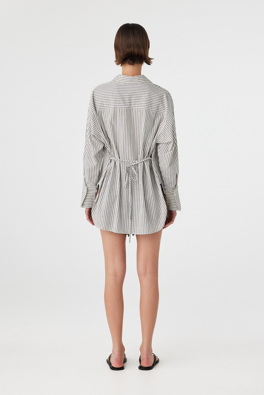 Model wearing a black and white striped shirt with a tie detail