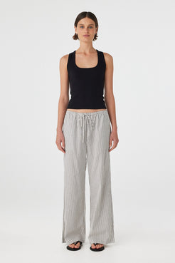 Full length front view of Rae Pants in black and white stripe styled with black tank