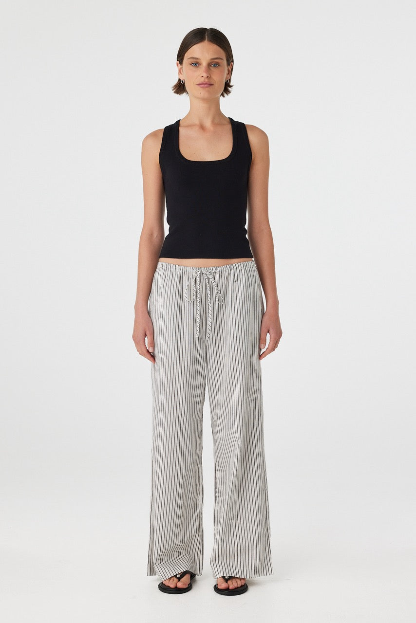 Full length front view of Rae Pants in black and white stripe styled with black tank