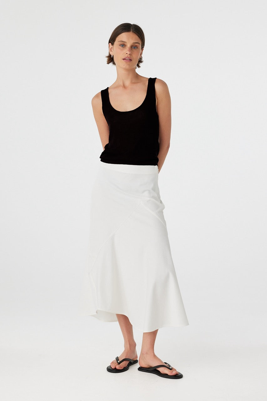 Model wearing black cotton knit tank top with scoop neckline, semi-sheer finish, and relaxed fit.