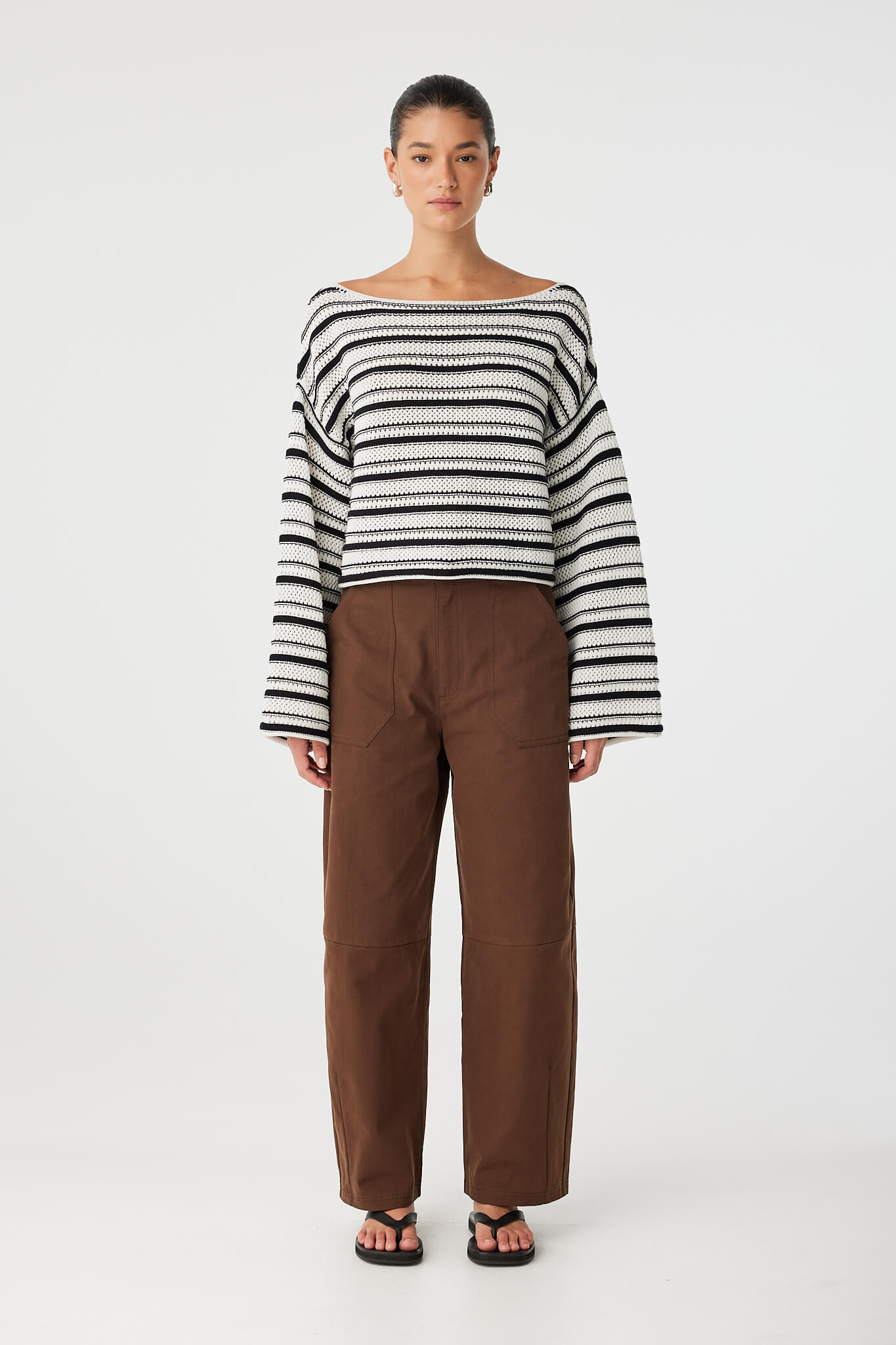 Full look of Maisie Sweater styled with brown pants, relaxed fit with airy open knit.