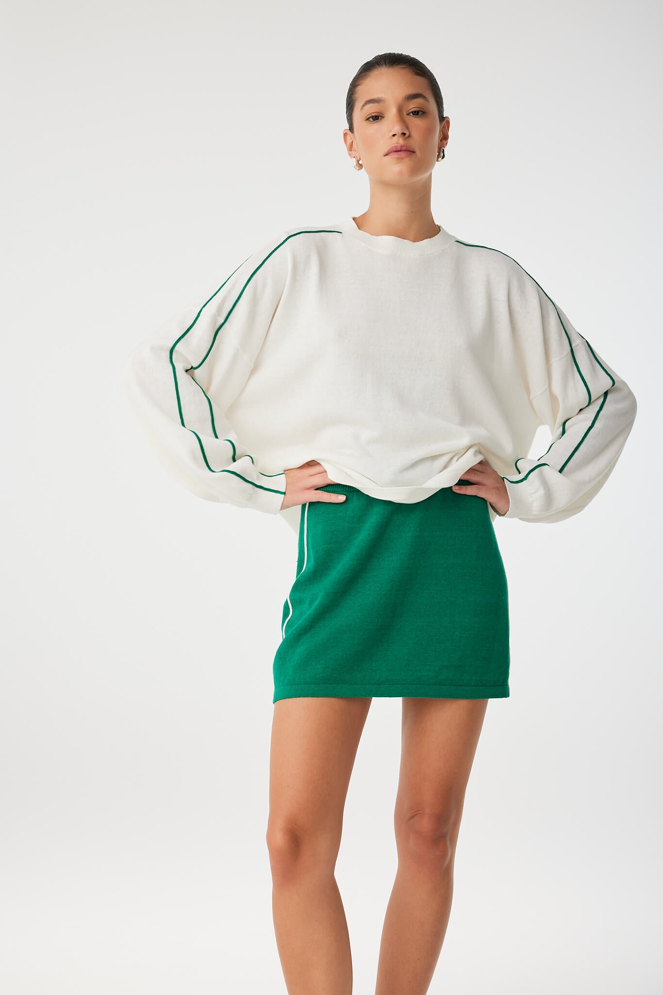 Pippa Mini Skirt styled casually with minimal top, highlighting shape and fit in motion.