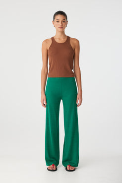Rio Tank styled with green wide-leg pants, showcasing close fit and athletic neckline.