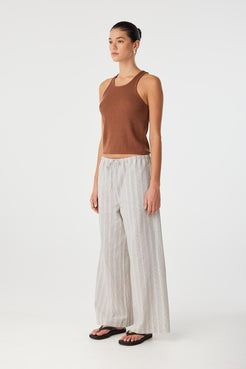 Angled side view showing relaxed cut and soft movement of striped cotton pant.