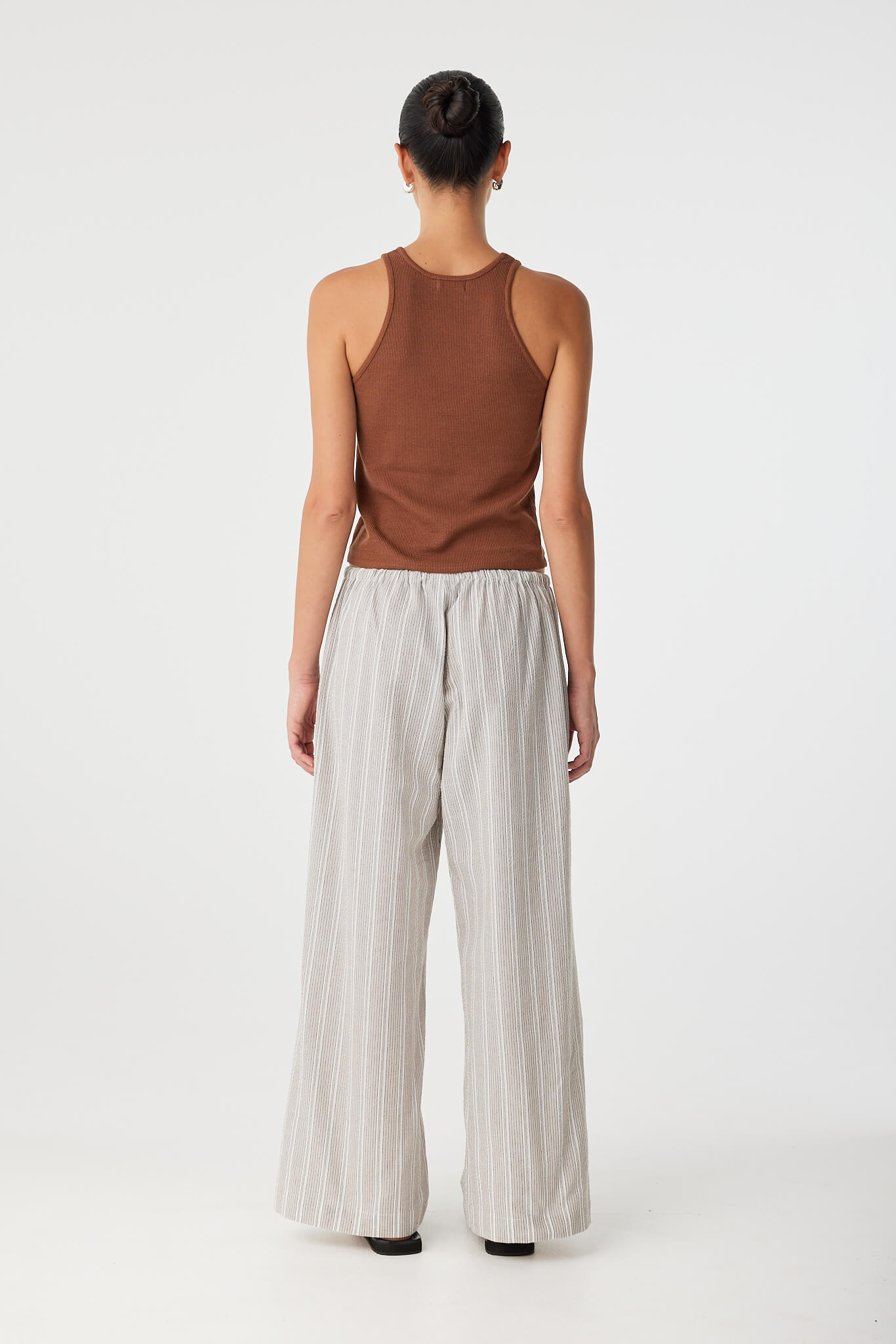Back view of lightweight cotton pant with elastic waistband and casual silhouette.