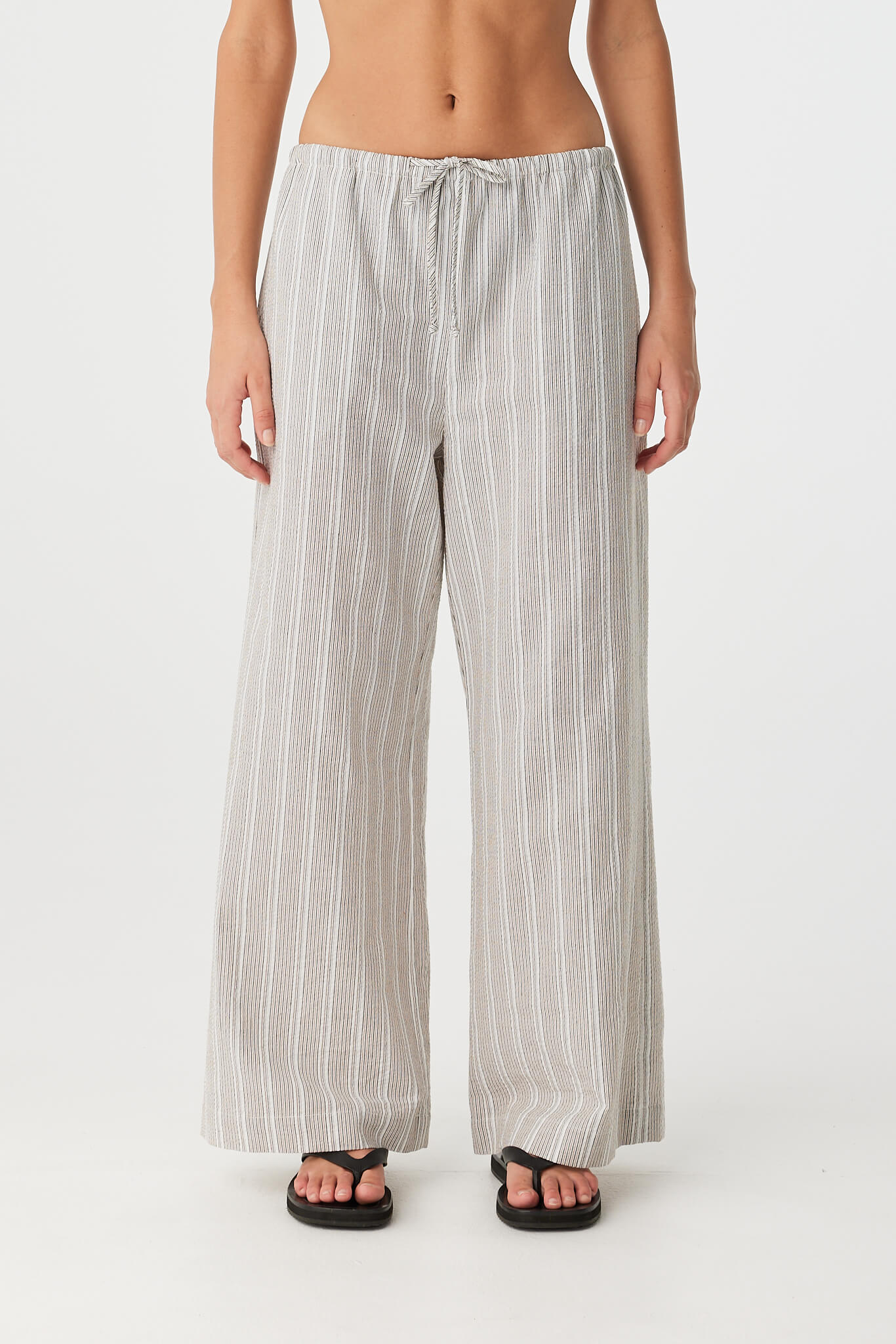 Front view of wide-leg striped cotton pant with drawstring waist and airy drape.
