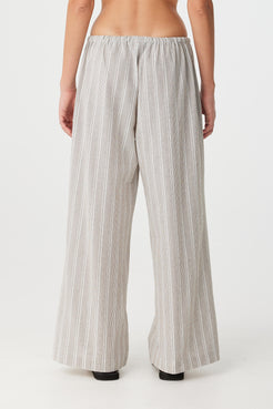 Back view of model wearing striped pant in soft cotton, showing relaxed drape and waistband.