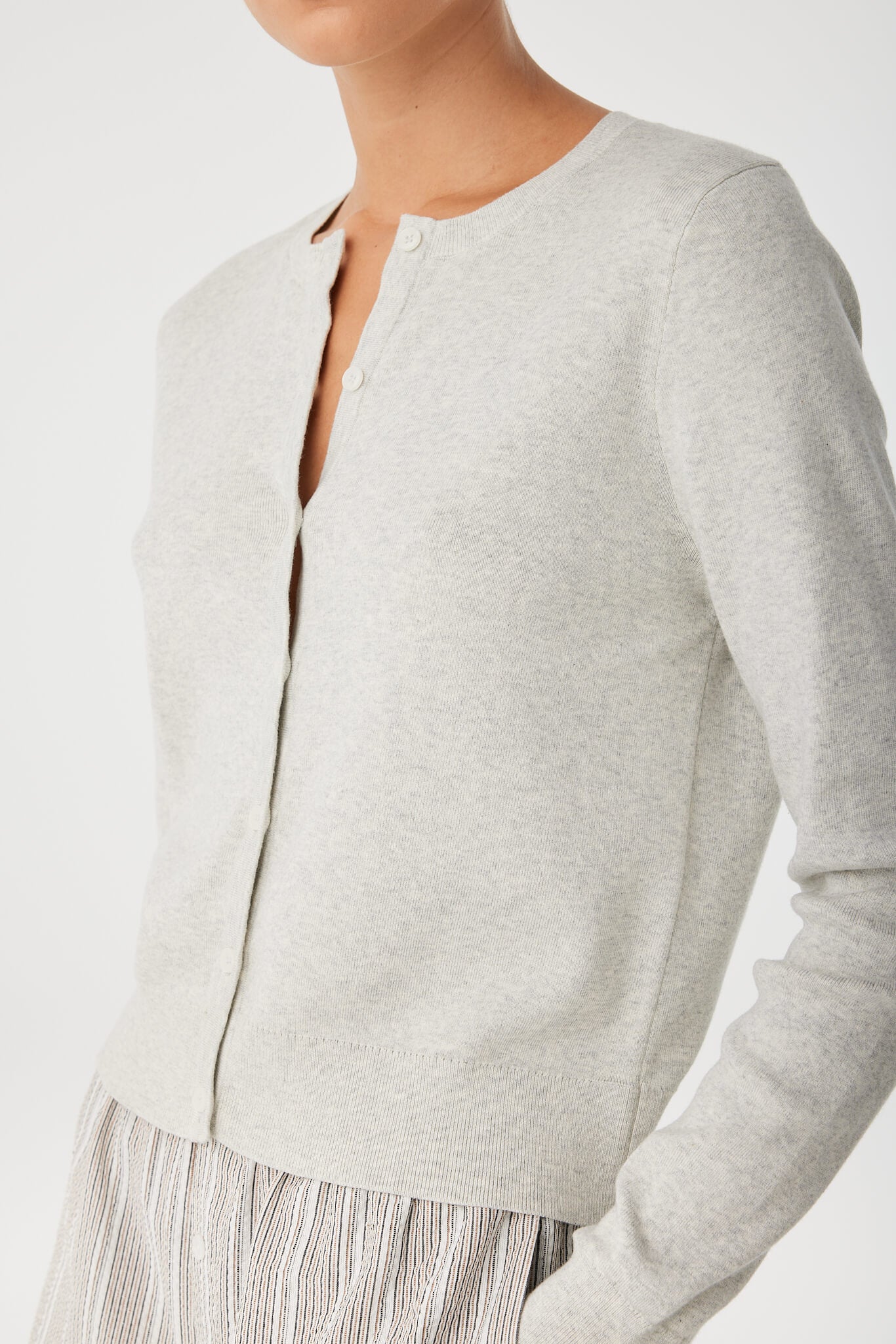 Close-up of neckline and premium smooth cotton knit on grey cardigan.