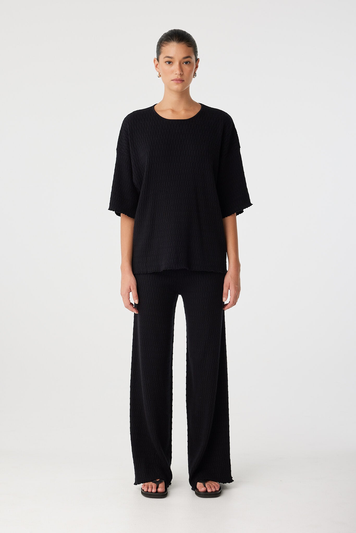 Model in full black look with Jude T-shirt and Jade pant showing drape and fit.