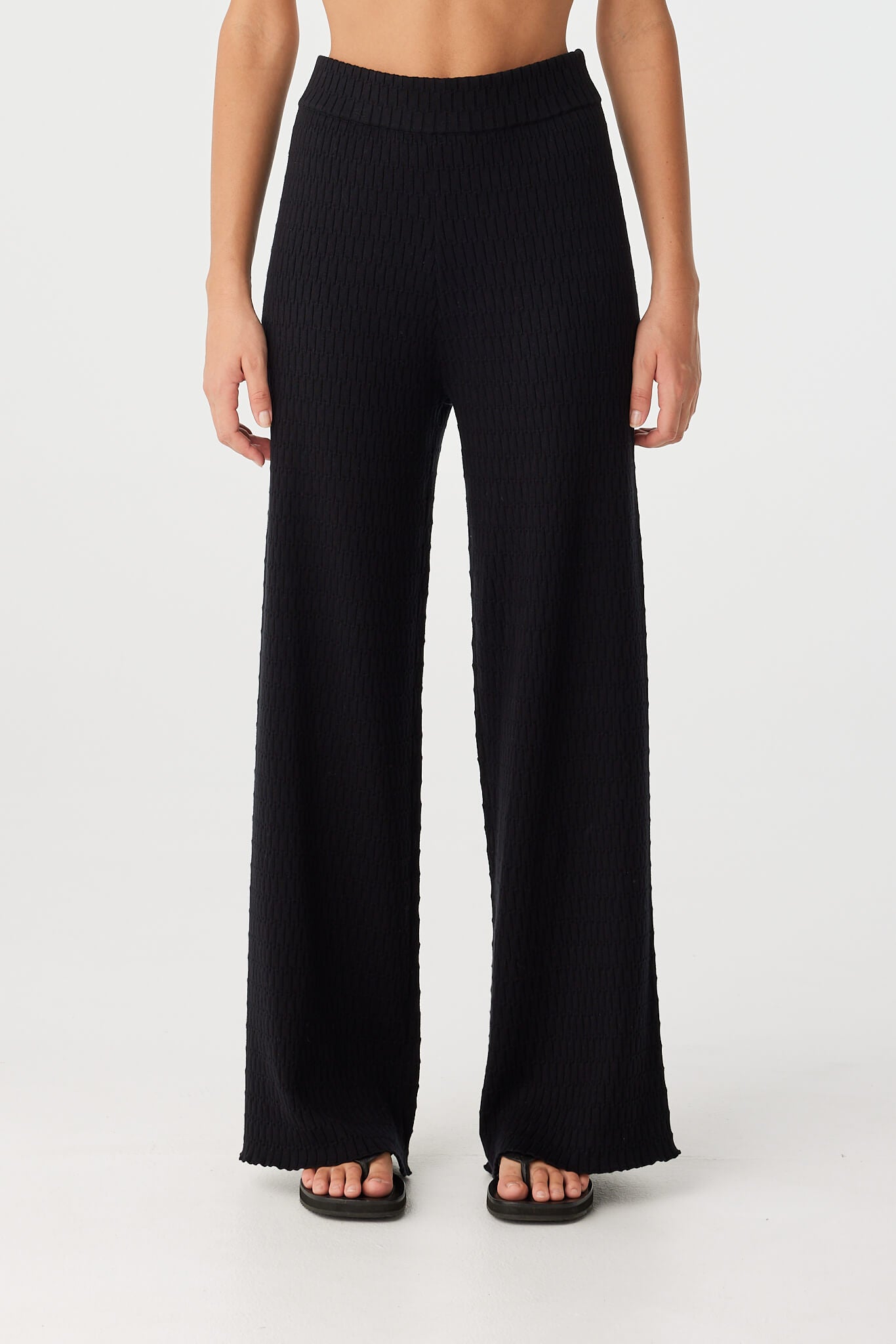 Front view of Jade straight leg pants in black organic cotton with textured knit and clean silhouette.