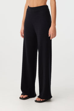 Angled view of straight-leg pant showing soft knit texture and elastic waistband.