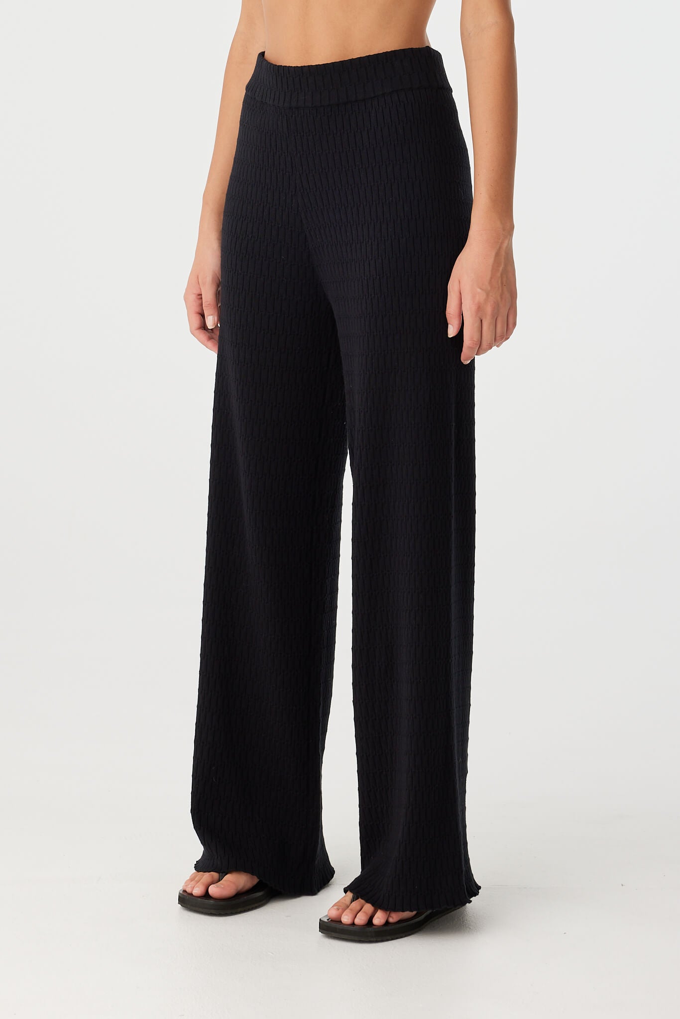 Angled view of straight-leg pant showing soft knit texture and elastic waistband.