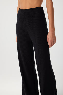Detail shot of side waistband and hip on black organic cotton pant with concealed elastic.