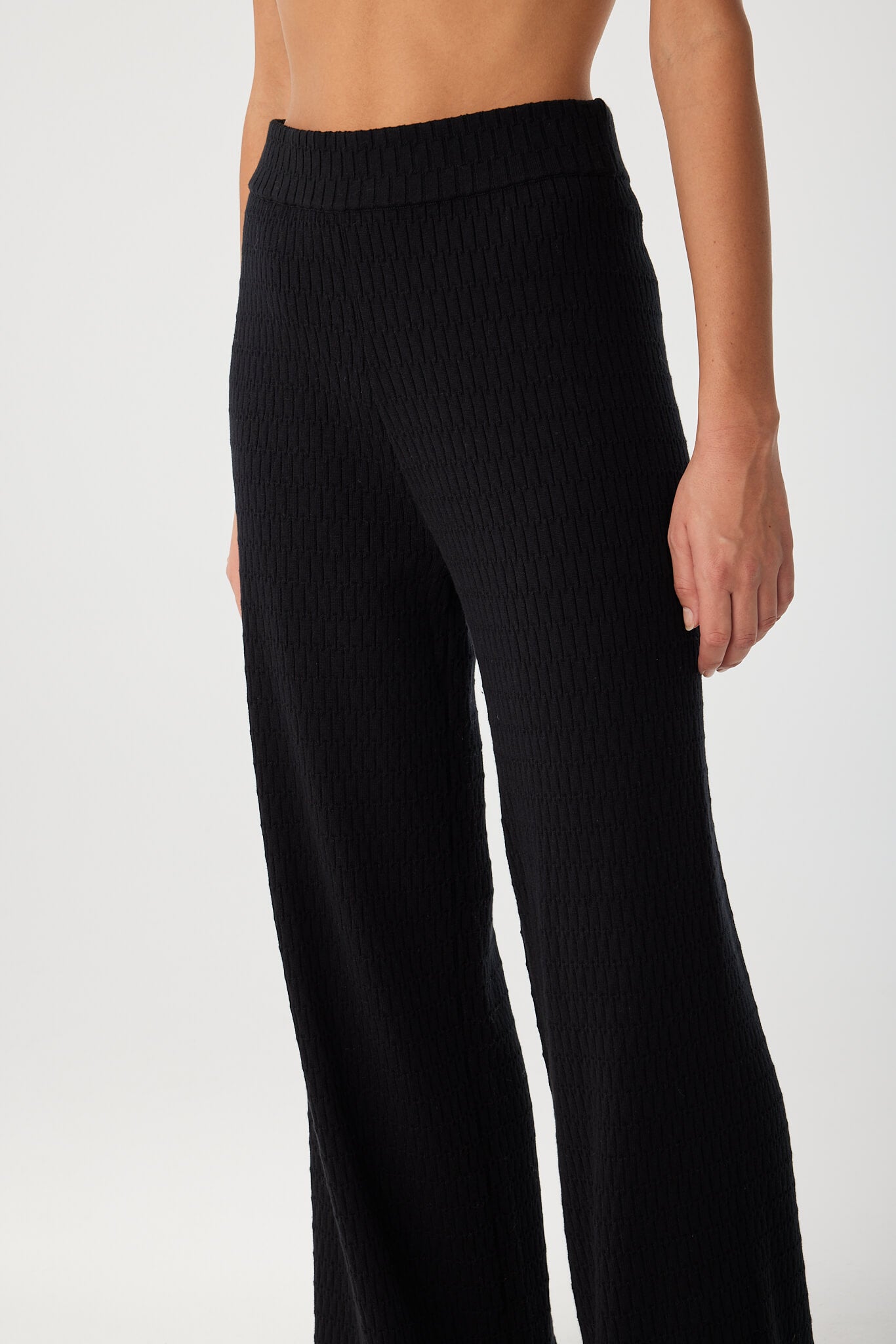 Detail shot of side waistband and hip on black organic cotton pant with concealed elastic.