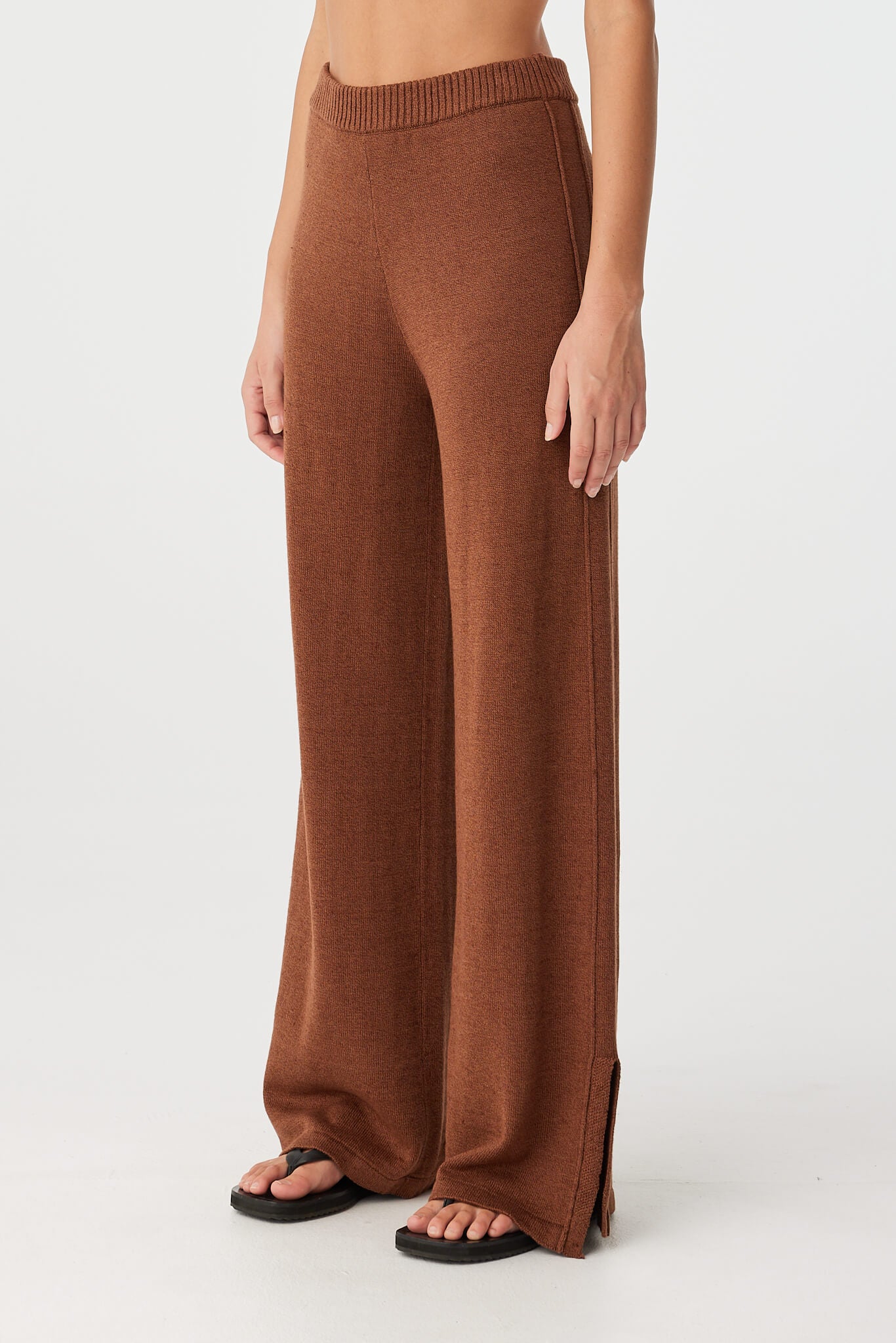 Side view of clay knit pant with subtle pleat detail and breathable texture.