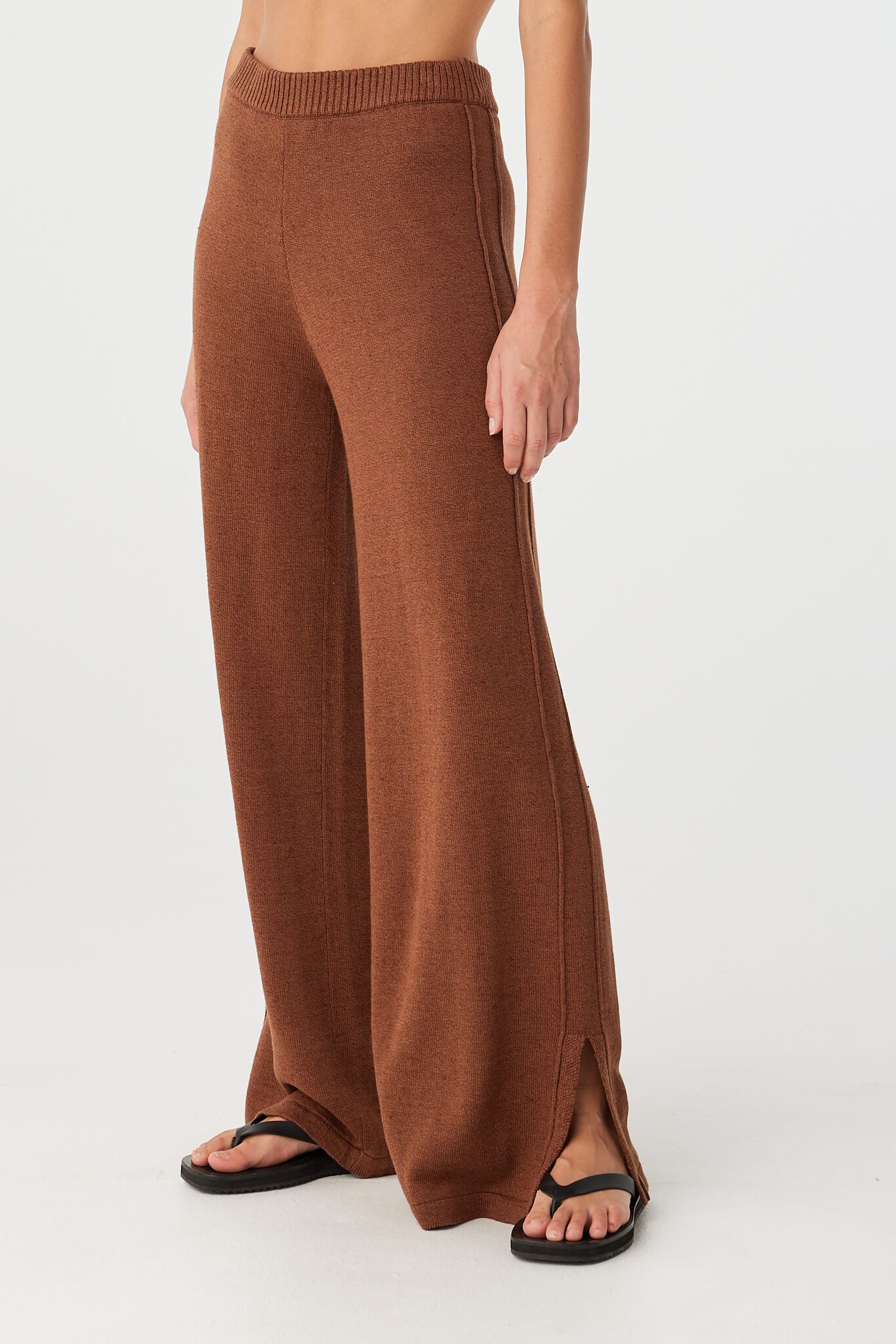 Relaxed clay linen–cotton pant shown with natural fall and fluid silhouette.