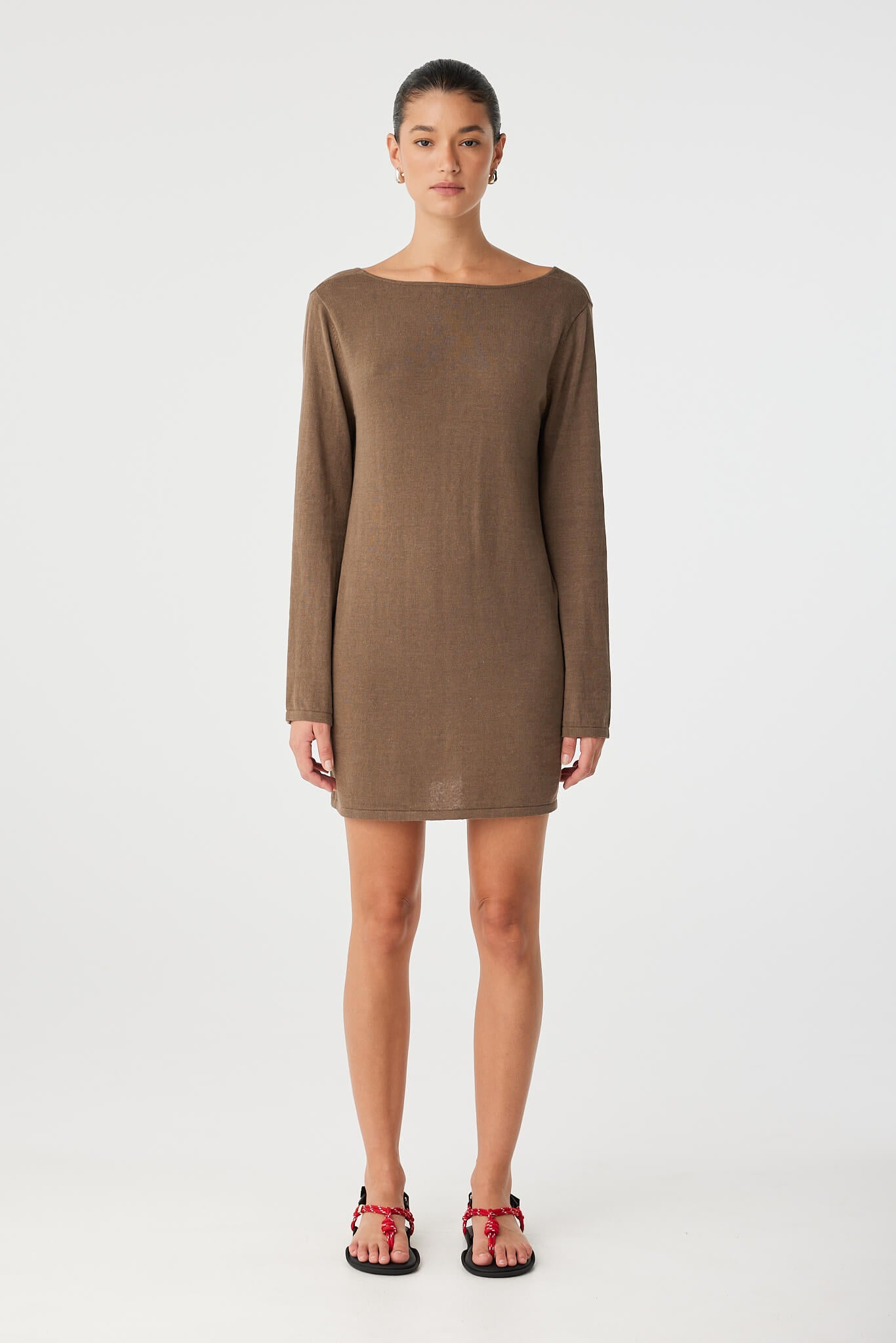 Model wears cacao long sleeve shift dress with boat neckline in linen–cotton blend.