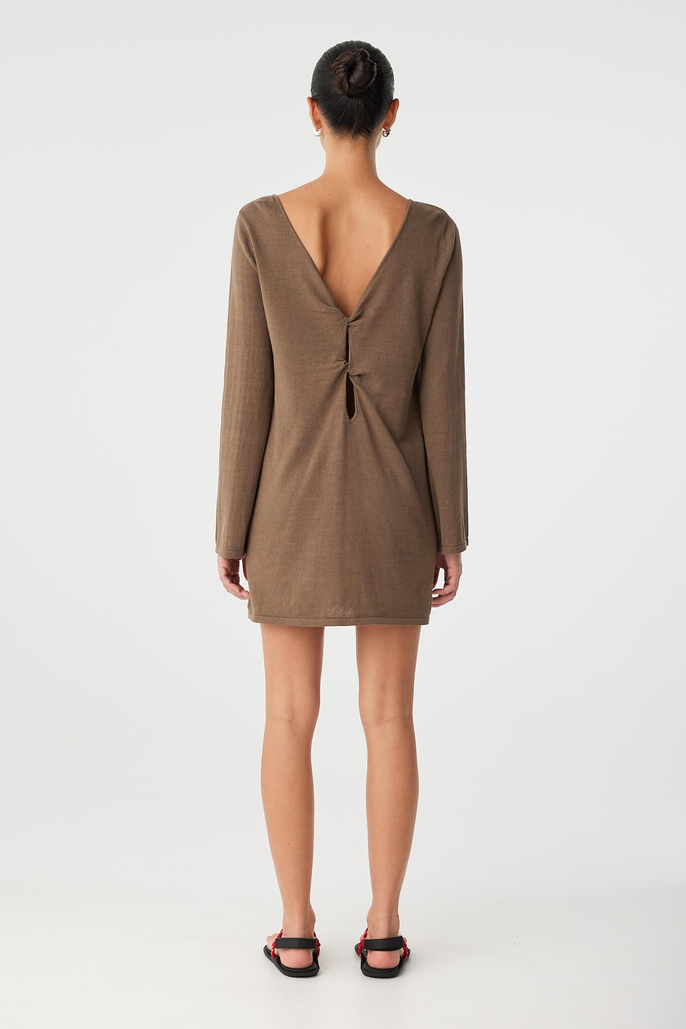 Back view of dress with twist cutout and deep V worn on reverse.