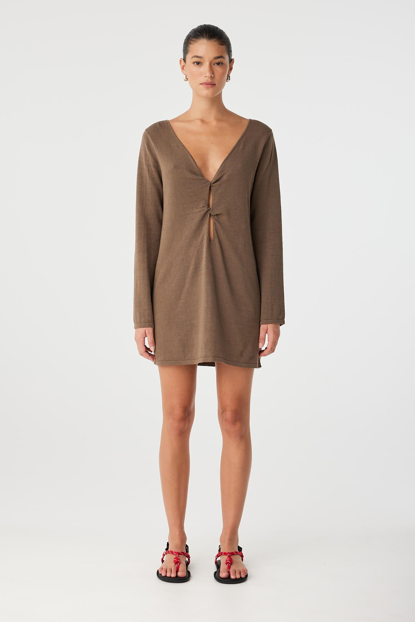 Paloma Dress styled with deep V neckline and twist cutout worn at front.