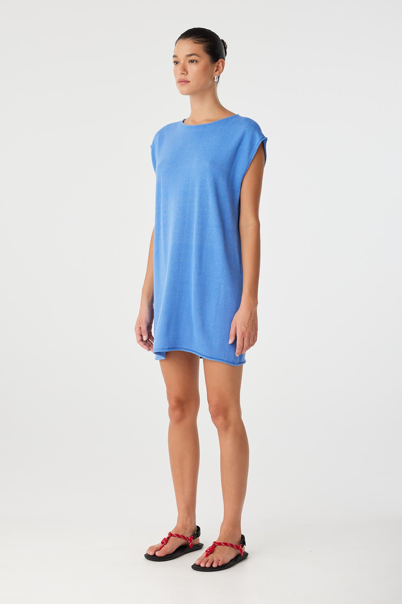 Worn with twist at back, showing high neckline and fluid shape of the reversible mini dress in soft textured weave.