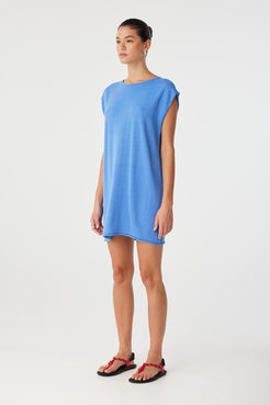 Worn with twist at back, showing high neckline and fluid shape of the reversible mini dress in soft textured weave.