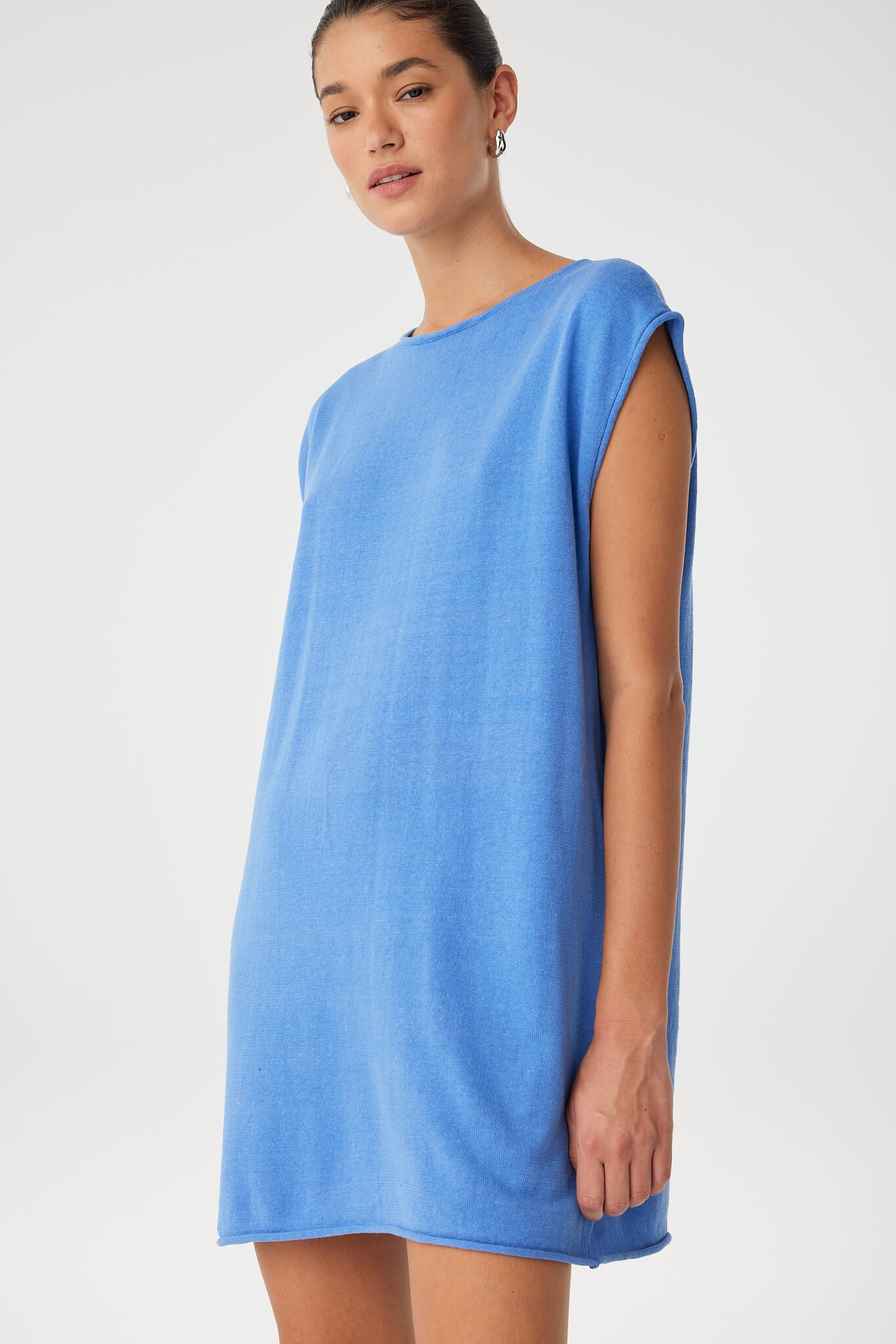 Side view showing twist-front detail and textured weave of pacific blue linen–cotton, designed for effortless summer dressing.